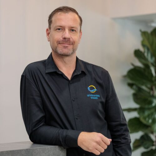 Alister Paskins professional headshot with tree in background