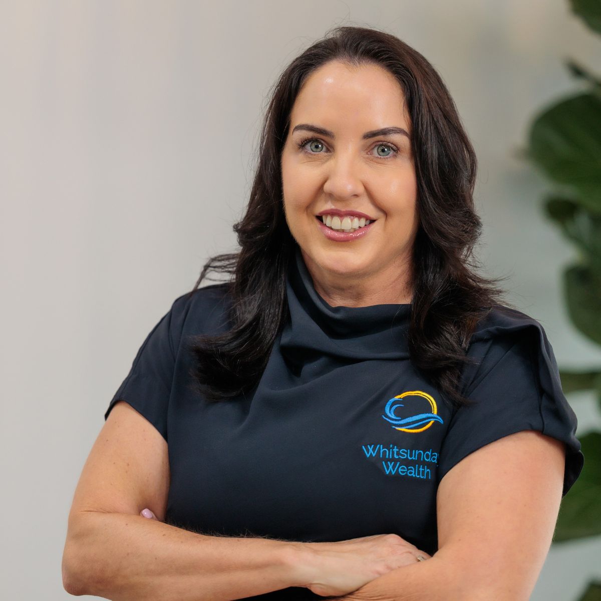 Kate Schembri professional headshot with plant in background