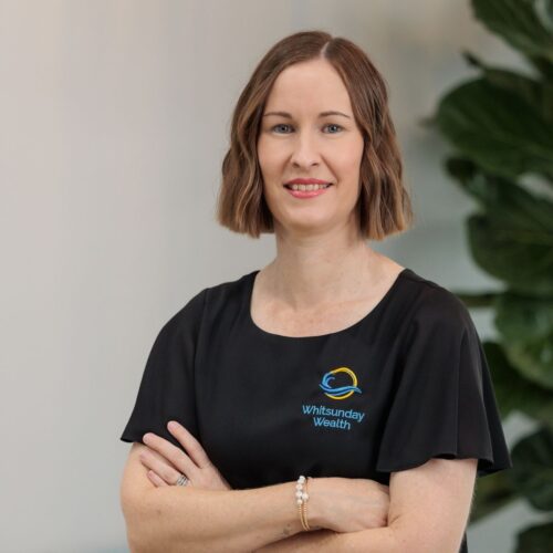 Michelle Ferris headshot crossing arms in Whitsunday Wealth office with plant in background